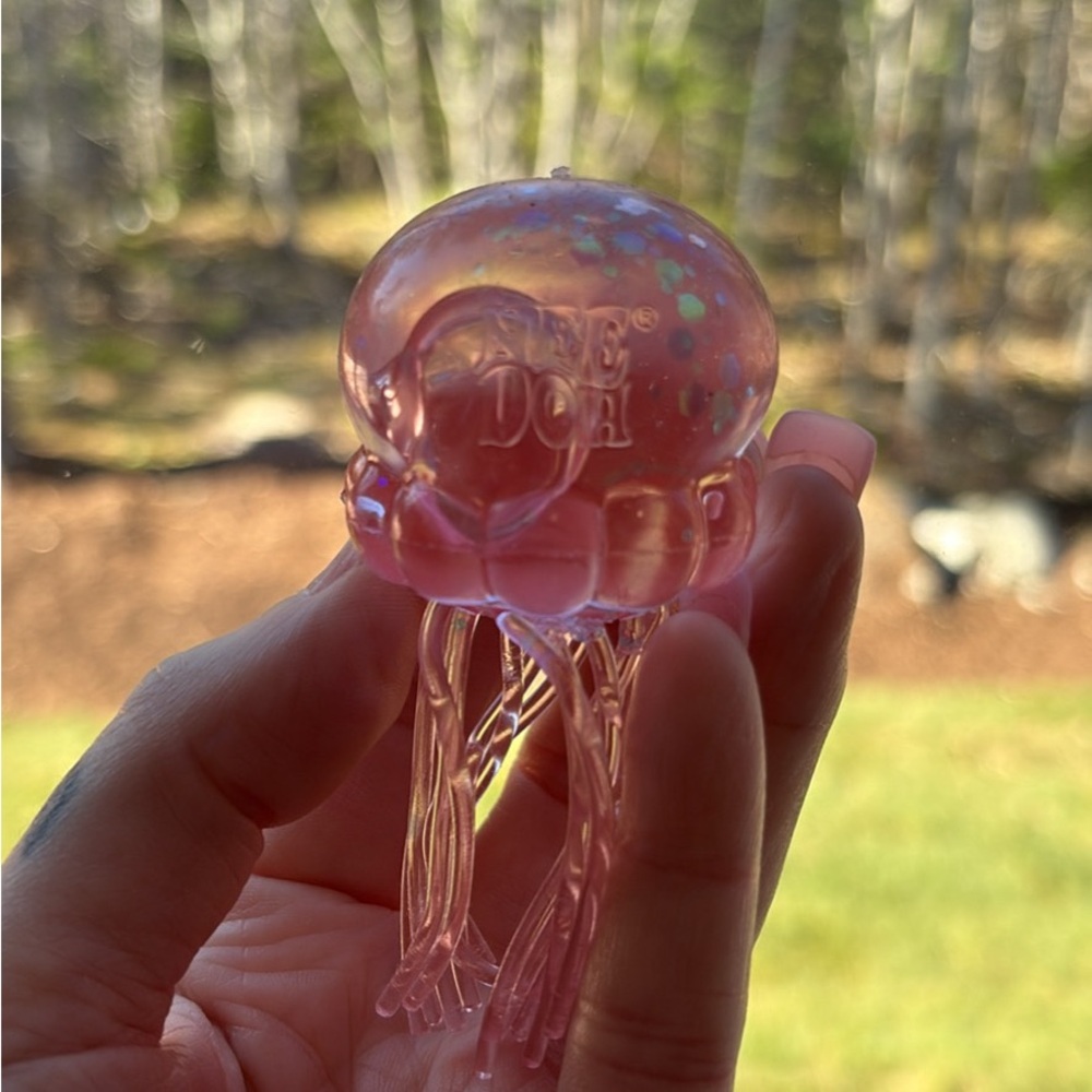 Translucent Pink Jellyfish Sensory Toy says “Needoh”